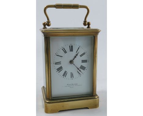 A brass cased carriage clock, the white enamel dial marked Mappin Brothers Paris, with striking movement, height including ha