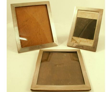 Three silver mounted photograph frames, all of rectangular form, two with engine turned decoration, all with wooden back, two