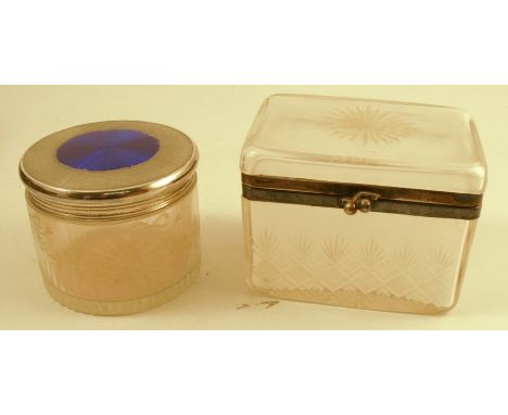 A silver and enamelled topped glass dressing table jar, the circular glass base engraved with ribbons and swags, the engine t