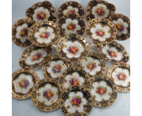 A Royal Worcester dessert service, each piece painted with a different still life of fruit by A Shuck, to a blue and gilt bor