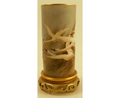 A Royal Worcester cylinder shaped spill vase, decorated with five swans on a powder blue ground, by Charles Baldwyn, raised o