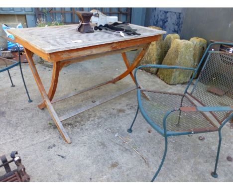 A TEAK GARDEN TABLE AND TWO WROUGHT IRON CHAIRS (3).