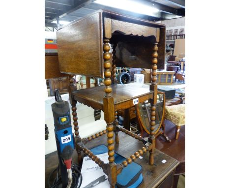 AN ANTIQUE OAK TWO TIER OCCASIONAL TABLE.