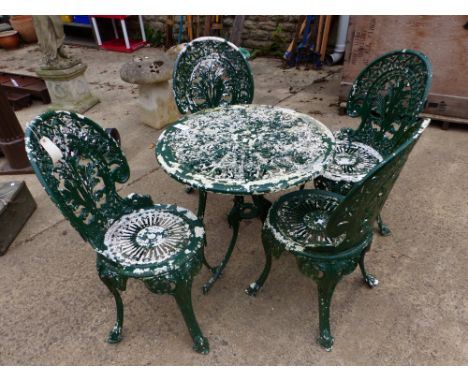 A SET OF FOUR CAST METAL PATIO CHAIRS AND A SIMILAR TABLE.