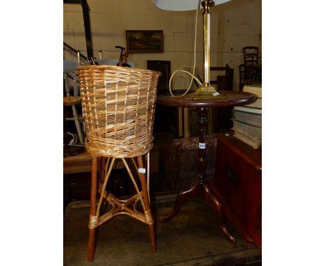 A WINE TABLE, A TABLE LAMP AND A RATTAN PLANT STAND