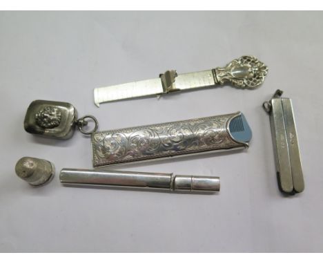 A collection of silver collectables to include a silver cased pair of scissors, a silver comb case and silver 3" ruler, a sil