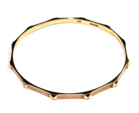A 9 carat gold bangle with engine turned decoration