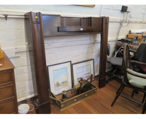 A 1920s mahogany mantelpiece, with inset shelf and moulded supports, 135cm wide