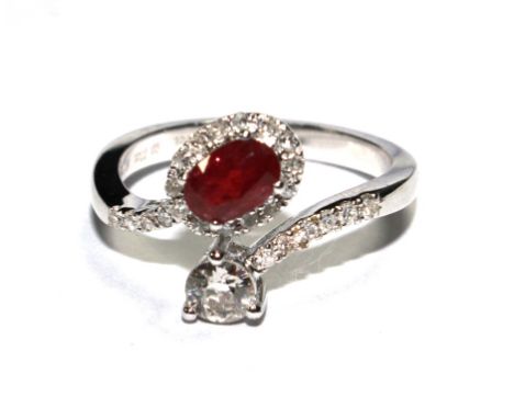 A ruby and diamond ring set in 18 carat white gold