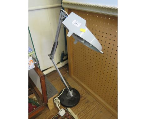 An anglepoise magnifying glass with light