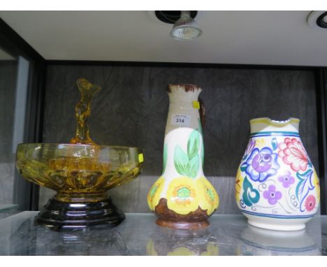 A 1920s amber glass bowl with flower holder and central nude figure, 22cm diameter, a Poole Pottery water jug, a Hancock's Iv