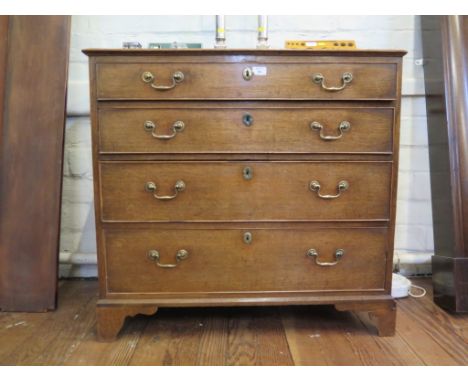 A George III oak chest of drawers, with four long graduated drawers on bracket feet, 91cm wide