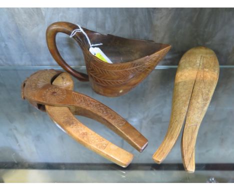 A Vintage Scandinavian wooden nutcracker modelled as a fish together with another pair and a carved wood small jug