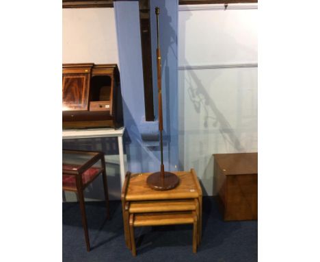A teak standard lamp and a nest of tables 