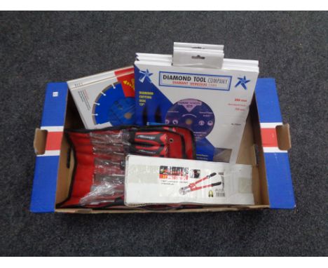 A box containing new tools including Neilsen 14 inch bolt cutter, three 7 piece wood chisel sets, diamond cutting disks 