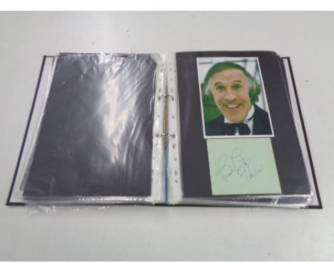 An album containing a collection of autographs, 20th century TV stars, Johnny Briggs, Danny Larue, Bruce Forsyth, and a small