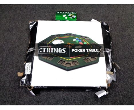 A poker table in box together with a boxed Texas Holdem card shuffler.  