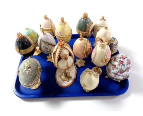 A tray containing a quantity of decorative egg ornaments on stands, two boxed cloisonne enamel eggs etc.     