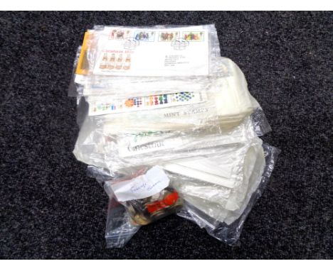 A box containing a small quantity of European coinage and First Day covers 
