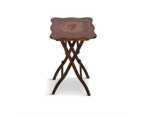 A FOLDING OAK SIDE TABLEthe shaped top with inlaid harp motif, raised on shaped square folding legs. 66cm high, 36cm wide, 36