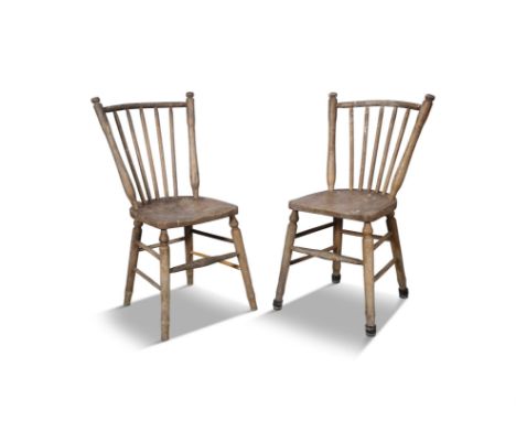 A PAIR OF 19TH CENTURY PAINTED PINE CURVED RAILBACK CHAIRS,the stick back and dished saddle seat, on splayed turned legs with