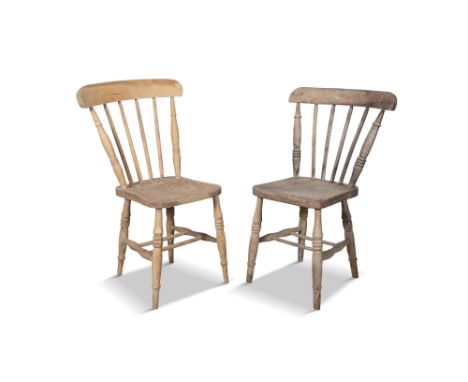 A MATCHED PAIR OF 19TH CENTURY PINE CURVED RAIL-BACK CHAIRS,the stick backs and dished saddle seats on splayed turned legs wi