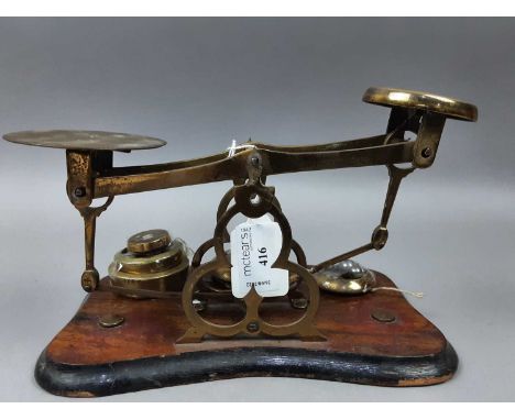 PAIR OF 19 TH CENTUARY POSTAL SCALES,with gothic revival trefiol devices, together with a set of graduated brass weights 22.5