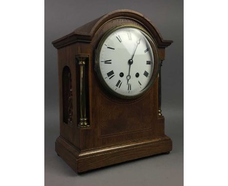 EDWARDIAN OAK CASED MANTEL CLOCK,the white enamel dial with numerals in black, eight day French movement stirking on a coil, 