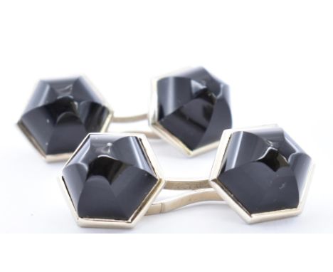 A pair of French Art Deco Ghiso 18ct white gold and onyx cufflinks. The cuff links with white and backs chains surmounted by 
