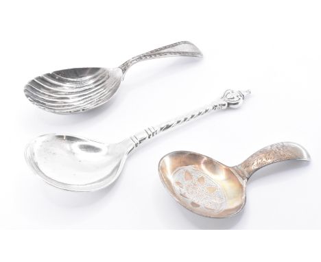 A group of three silver hallmarked caddy spoons. The lot includes a George IV Georgian silver hallmarked shell moulded spoon,
