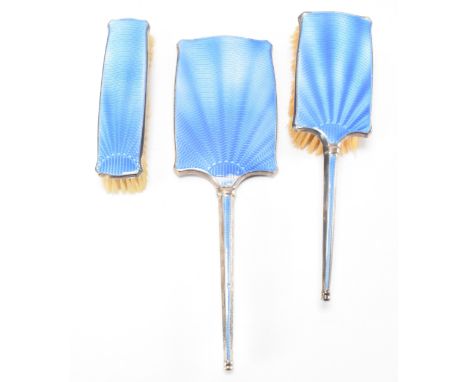 A 1930s Art Deco hallmarked sterling silver dressing table set having blue enamelling to the backs. The set to include a hair