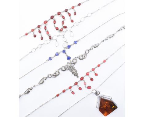 An assortment of silver necklaces to include a 1930s style marcasite set necklace, a necklace having geometric style amber pe