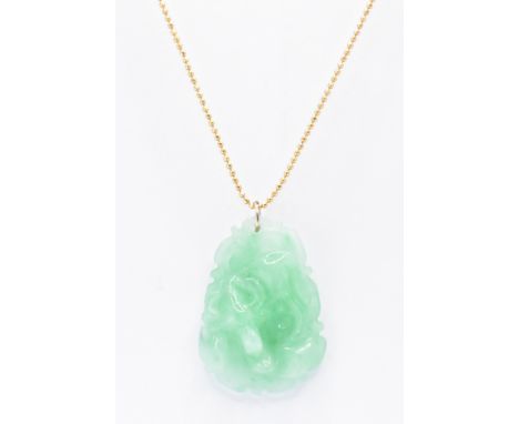 An 18ct gold chain necklace with carved jade pendant. The necklace having bead links and the hade pendant carved in relief to