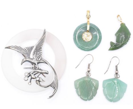 A group of Chinese green hard stone jewellery to include a aventurine quartz roundel pendant with a gold plated centre and ba