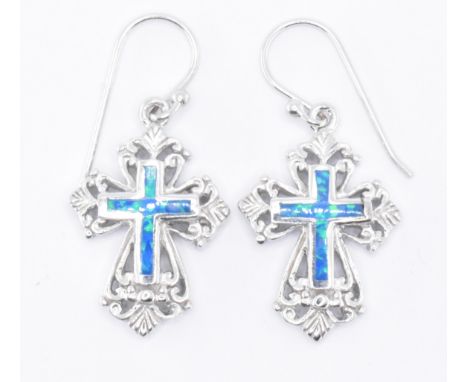 A pair of silver crucifix cross earrings with enamel to the centre and ornate gothic style edges. Measures 25mm in length. To