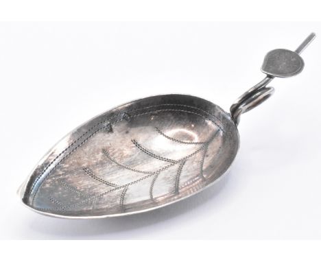 A silver hallmarked George III Georgian caddy spoon in the form of a leaf with a scrolled vine leaf handle. Hallmarked with d
