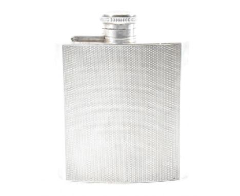 A hallmarked silver 1930s Henry Clifford Davis hip flask. The flask having engine turned decoration to the body and bayonet s