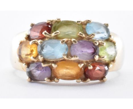 A 14ct gold ring being set with ten oval cut gemstones. The ring set with three rows of red, yellow, purple, green and blue s