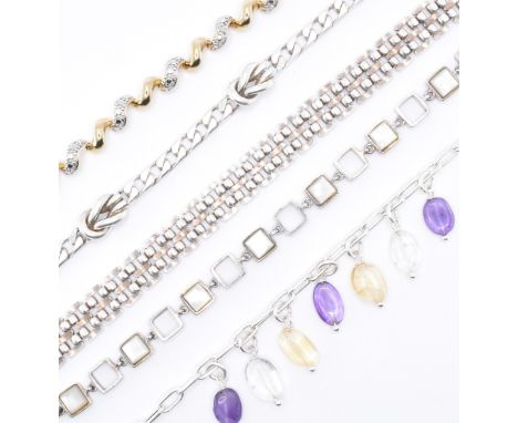 An assortment of five silver bracelets to include a silver chain bracelet with amethyst , citrine, quartz bead drops, a gilt 