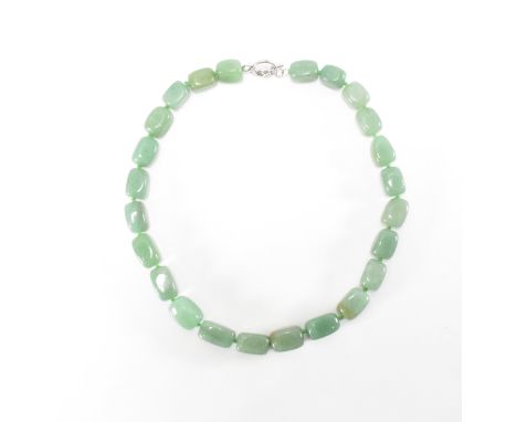 A silver and jade beaded necklace.The necklace having twenty four polished square beads with a silver toggle clasp. Clasp mar