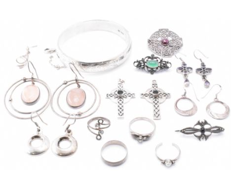 An assortment of silver jewellery to include a hallmarked silver bangle bracelet, a Celtic cross brooch with garnet cabochon 