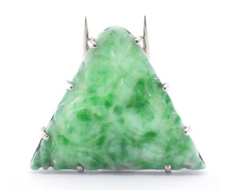 A 1920s /1930s Art Deco jade and white gold dress clip. The antique dress clip having a triangular jade panel with carved det