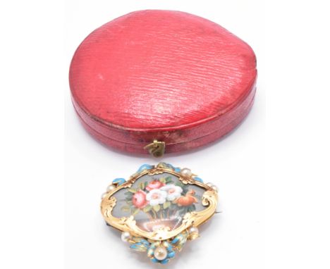 A gold, pearl and turquoise enamel Jardiniere clip brooch. Decorated with a central porcelain panel depicting a basket of flo