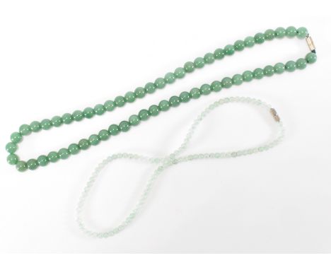 A jade beaded necklace having round polished beads together with a smaller aventurine quartz beaded necklace. Both having scr