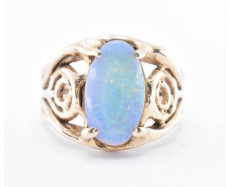 A 9ct gold and opal doublet ring. The ring with a central oval doublet opal within a pierced setting. Ring size Q. Total weig