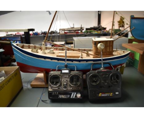 A hand built radio controlled wooden scale model Boat having brass propeller and rudder, on wooden stand with two Ranger Cont