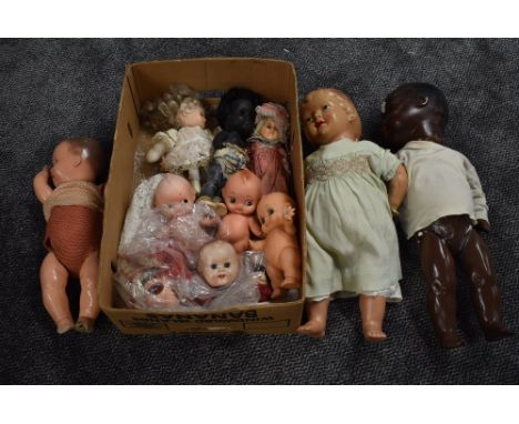 A shelf of 1950's and later composition, celluloid and similar dolls including Armand Marseille black Baby Doll having sleep 