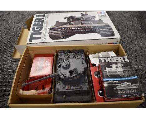 A Tamiya plastic 1/16 scale model radio controlled German Tiger I Tank, numbered S33, controller and instructions present