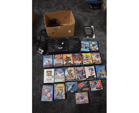 A Sega 16 - Bit Mega Drive Console with Mega CD II along with controllers and power supply along with 16 game cartridges incl