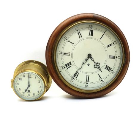 An unsigned wall clock, 20th century, in oak case, the enamel dial with Roman numerals, minute track and scroll hands, having
